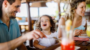 Little girl laughing in restaurant